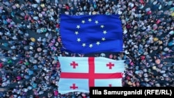 Georgians rally in the capital, Tbilisi, with Georgian and EU flags to show their support for joining the bloc.