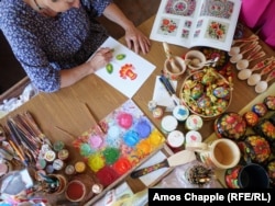 Petrykivka master artist Natalya Rybak at work on June 27.