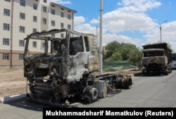 Trucks burnt during protests in Nukus on July 6.