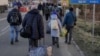 Ukrainian refugees cross the border into Romania at the Siret customs point on February 24.