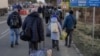 Ukrainians fleeing the violence in their homeland cross the border into Romania on Ferbuary 25. 