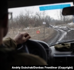 A sign warning of land mines is seen from a vehicle near the front lines in eastern Ukraine in early January.