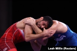 Hassan Yazdanicharati of Iran (left) competes against David Taylor of the United States at the Tokyo Olympics in August 2021.