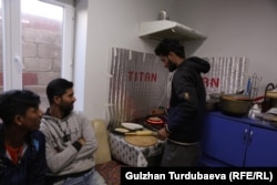 Bangladeshis who came to work in Kyrgyzstan prepare a meal at a Bishkek apartment.