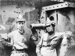 Red Army soldiers stand alongside an armored train used in the war.