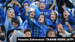 Female fans of Iran's Esteghlal football club cheer during a match between Esteghlal and Mes-e Kerman at Azadi Stadium in Tehran on August 25. It was the first time Iranian women were allowed to attend a national football championship match since the 1979 Islamic Revolution.