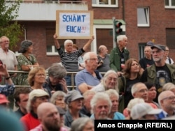 Ruth Plotzer protests the Marx statue unveiling.