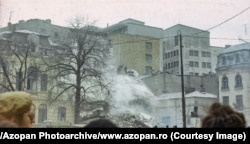 Workers remove rubble from a destroyed building in central Bucharest.