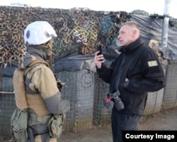 Ukrainian photojournalist Andriy Dubchak (right), who founded the Donbas Frontliner Media project and is currently working near Mariupol, on the southeastern coast of Ukraine.