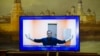 The late Russian opposition leader Aleksei Navalny appears on a TV screen during proceedings in a hearing of his appeal at a court in Moscow in January 2021. 