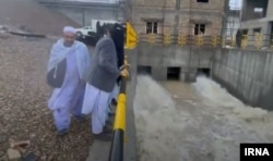 Bystanders watch water being released from the Kamal Khan Dam in Afghanistan on January 20.