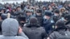 Police talk with demonstrators protesting fuel prices in the western Kazakh city of Oral on January 4. 