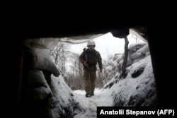 A Ukrainian fighter walks along a trench in the Luhansk region on January 22.