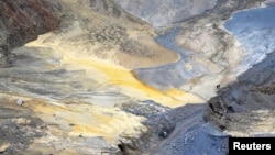 Two miners walk through a open copper pit in the Serbian town of Bor. (file photo)