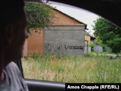 Graffiti in an area of Hostomel that was occupied by Russian forces. The word says “Wolves” with a date from when Russians held the area.