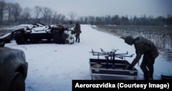 An Aerorozvidka drone team with an R18 octocopter. The eight arms of an octocopter mean that even if one rotor fails or is destroyed by a bullet the aircraft can return to base safely.