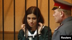 Pussy Riot member Nadezhda Tolokonnikova looks out from a holding cell during a court hearing in the town of Zubova Polyana on April 26.