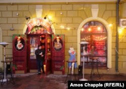 A man exits a store specializing in cherry liqueur in the center of Mariupol on February 6.