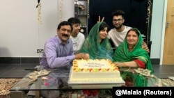 Malala Yousafzai (center) celebrates graduating from Oxford University at an undisclosed location on June 18.