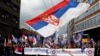 Protesters wave a large Serbian flag during a demonstration against NATO in Belgrade in March 2016. 