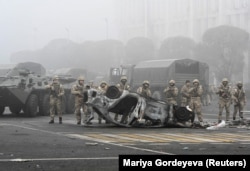 Troops are seen on the main square, where hundreds of people were protesting against the government in Almaty on January 6.