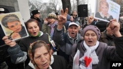 Opposition activists hold portraits of jailed Ukrainian opposition leader Yulia Tymoshenko during a rally held outside the parliament in Kyiv on November 13.