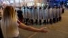 A woman gestures toward riot police in the city of Homel on August 10.