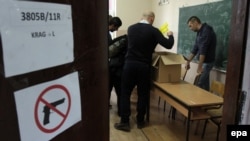 Kosovar election-committee members prepare for voting at a polling station Mitrovica on November 3.