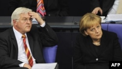 German Foreign Minister Frank-Walter Steinmeier and Chancellor Angela Merkel at a Bundestag debate in October over German troops' mandate in Afghanistan.