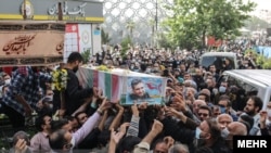 Mourners carry the coffin of Colonel Hassan Sayad Khodaei from Iran's Islamic Revolutionary Guards Corps, who was killed in Tehran on May 22. 