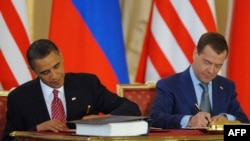 U.S. President Barack Obama (left) and his Russian counterpart Dmitry Medvedev sign the initial treaty in Prague in April.