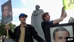 Supporters carry pictures of Mikhail Khodorkovsky outside the the State Duma.