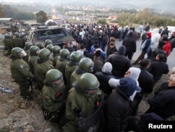 Protesting Kosovo Serbs stand on the street in front of NATO's Kosovo Force (KFOR) soldiers from Germany in the village of Jagnjenica near the town of Zubin Potok on October 20.