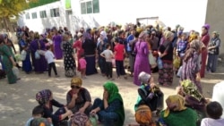 People queue up in front of a state grocery store to buy cooking oil in Mary.