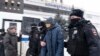 Police detain a participant of the Municipal Russia conference in Moscow on March 13.