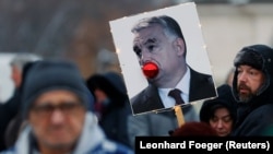 A placard depicting Hungarian Prime Minister Viktor Orban is pictured during a protest against the labor law in Budapest on December 16.