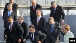 The heads of NATO member states step off the podium where they took a family photo in Strasbourg on April 4.