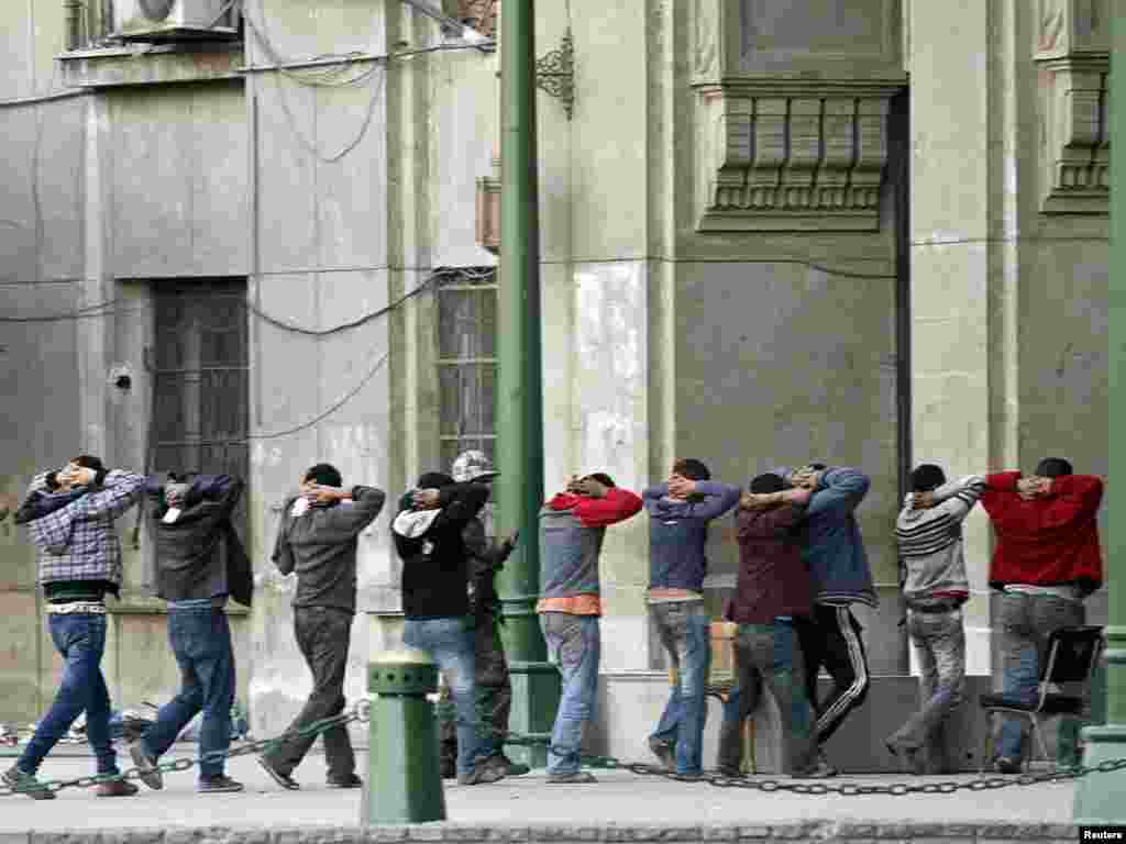 Mubarak protesters captured by antigovernment protesters are handed over to the army during rioting in Cairo.