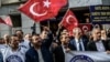 A protester waves Turkey's national flag while others shout slogans in front of the Russian Consulate in Istanbul during a demonstration against Russia's Syria policy on November 24.