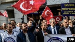 A protester waves Turkey's national flag while others shout slogans in front of the Russian Consulate in Istanbul during a demonstration against Russia's Syria policy on November 24.