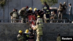 Afghan officials transport a victim after a suicide attack in Kabul on September 5.