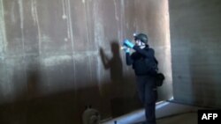 An inspector from the Organization for the Prohibition of Chemical Weapons (OPCW) works at an undisclosed location in Syria on October 10.