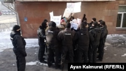 Protesters are surrounded by police on election day on January 10.