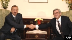 Azerbaijani President Ilham Aliyev (left) and Armenian President Serzh Sarkisian meet on the sidelines of a CIS summit in Chisinau in October 2009.