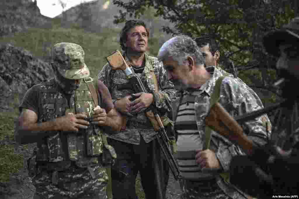 Ethnic Armenian men with Soviet-made weapons in a village in Nagorno-Karabakh -- a breakaway region which is internationally recognized as part of Azerbaijan -- on October 23. &nbsp;