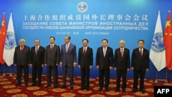 Foreign ministers of the Shanghai Cooperation Organization member states pose for a group photo before a council meeting of foreign ministers at the Diaoyutai State Guesthouse in Beijing on May 11.