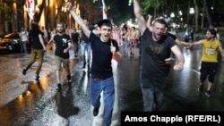 Protesters march through central Tbilisi during a rainstorm. 