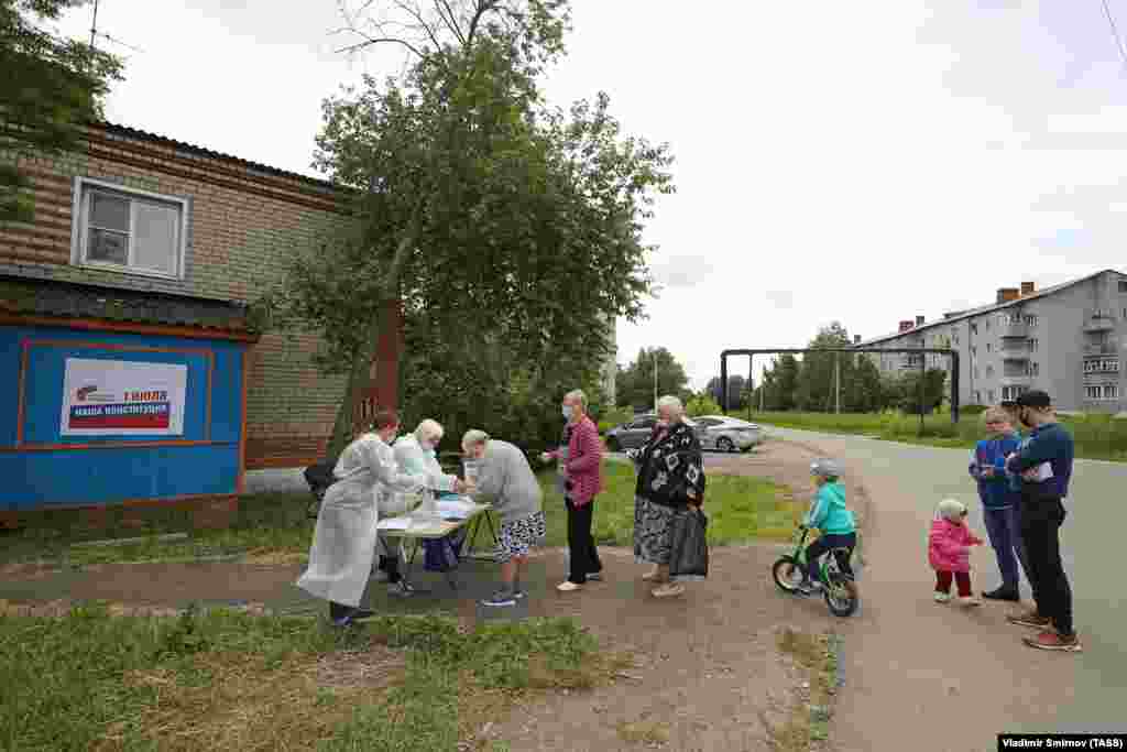 Residents visit an outdoor polling station in the village of Lugovoye.