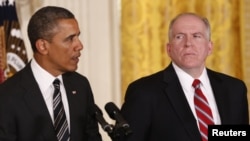 White House counterterrorism adviser John Brennan (right) listens as U.S. President Barack Obama nominates him to become the next CIA director at the White House in Washington on January 7. 