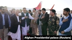 Afghan President Ashraf Ghani (in mask) arrives in Mazar-e Sharif to check the security situation of the northern provinces on August 11.